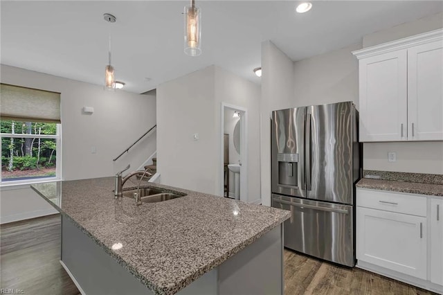 101 Daybeacon St, Yorktown, VA 23692 - kitchen with stainless steel fridge, a sink, stone countertops, wood finished floors, and recessed lighting