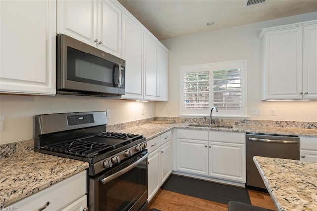 145 Beacon Run, Suffolk, VA 23435 - kitchen with stainless steel appliances, a sink, white cabinetry, and dark wood-type flooring