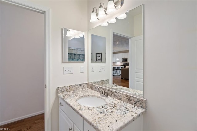 145 Beacon Run, Suffolk, VA 23435 - bathroom featuring vanity, a chandelier, wood finished floors, and baseboards