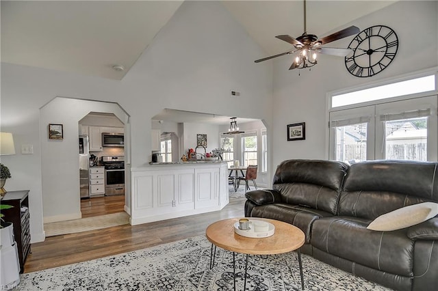 3145 Crestwood Ln, Virginia Beach, VA 23453 - living room with arched walkways, wood finished floors, ceiling fan, a chandelier, and high vaulted ceiling