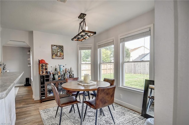 3145 Crestwood Ln, Virginia Beach, VA 23453 - dining space with light wood finished floors, baseboards, and arched walkways