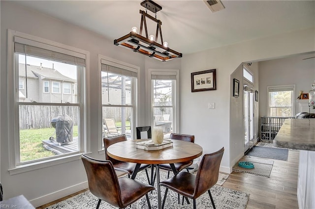 3145 Crestwood Ln, Virginia Beach, VA 23453 - dining area featuring baseboards, wood finished floors, and a chandelier