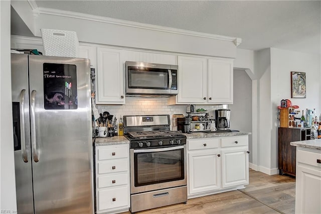 3145 Crestwood Ln, Virginia Beach, VA 23453 - kitchen featuring appliances with stainless steel finishes, light wood-type flooring, white cabinetry, and crown molding