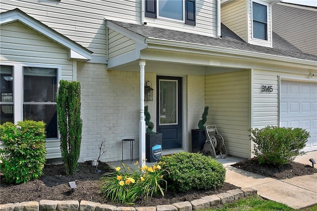 3145 Crestwood Ln, Virginia Beach, VA 23453 - doorway to property with brick siding, a shingled roof, and an attached garage