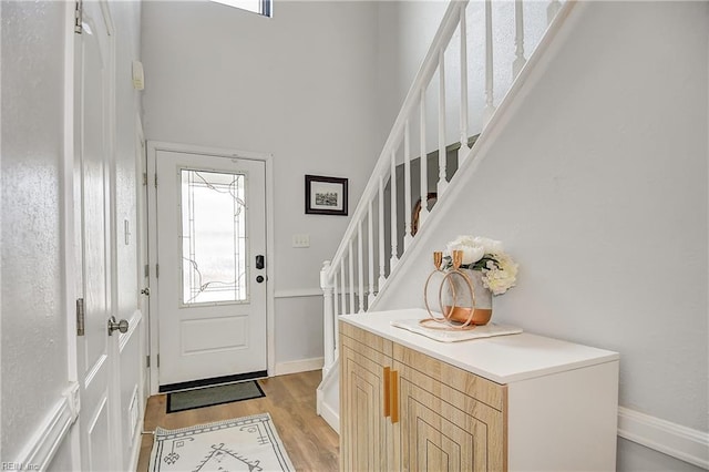 3145 Crestwood Ln, Virginia Beach, VA 23453 - entrance foyer with stairs, light wood finished floors, baseboards, and a towering ceiling