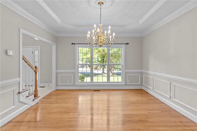 2288 Souverain Ln, Virginia Beach, VA 23454 - unfurnished dining area with a chandelier, light wood-style floors, a raised ceiling, ornamental molding, and stairway