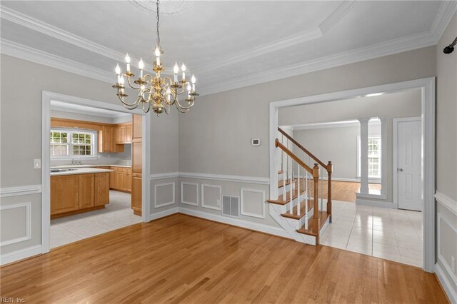 2288 Souverain Ln, Virginia Beach, VA 23454 - unfurnished dining area with light wood-style flooring, stairway, a chandelier, ornamental molding, and wainscoting