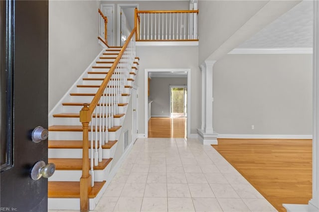 2288 Souverain Ln, Virginia Beach, VA 23454 - foyer with ornate columns, stairs, marble look tile flooring, baseboards, and a towering ceiling