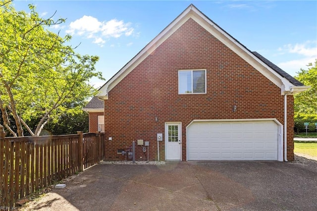 2288 Souverain Ln, Virginia Beach, VA 23454 - view of side of home with brick siding, asphalt driveway, and a garage