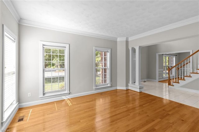 2288 Souverain Ln, Virginia Beach, VA 23454 - unfurnished room featuring light wood finished floors, stairs, decorative columns, baseboards, and ornamental molding