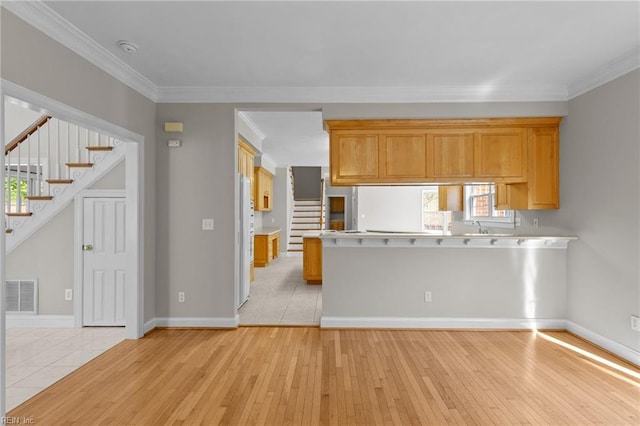 2288 Souverain Ln, Virginia Beach, VA 23454 - kitchen featuring light wood-style floors, light countertops, ornamental molding, and a peninsula