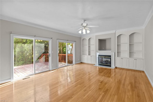 2288 Souverain Ln, Virginia Beach, VA 23454 - unfurnished living room featuring crown molding, wood-type flooring, built in shelves, ceiling fan, and a glass covered fireplace