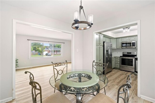 813 Hilltop Rd, Virginia Beach, VA 23454 - dining room with a chandelier, light wood-style flooring, and baseboards
