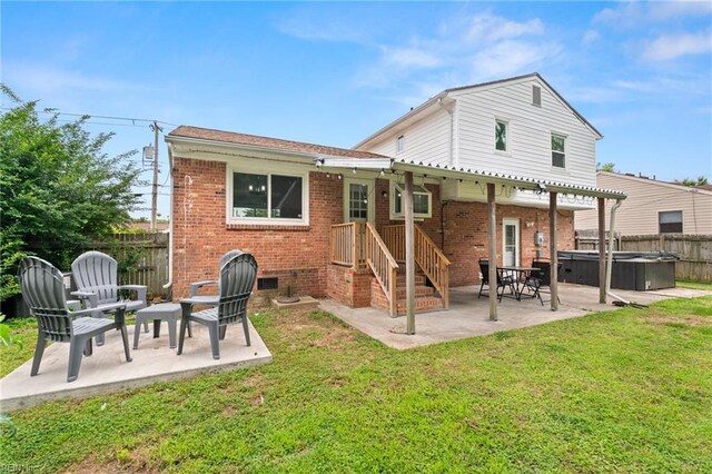 813 Hilltop Rd, Virginia Beach, VA 23454 - back of house with a hot tub, a patio, and brick siding