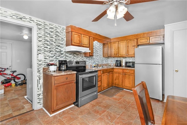 1204 Blythewood Ln, Suffolk, VA 23434 - kitchen with appliances with stainless steel finishes, under cabinet range hood, ceiling fan, decorative backsplash, and light countertops