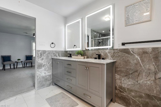 128 Wellons St, Suffolk, VA 23434 - full bathroom with tile walls, double vanity, a shower with shower door, marble look tiles, and ceiling fan