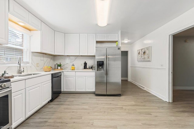 128 Wellons St, Suffolk, VA 23434 - kitchen featuring stainless steel appliances, a sink, light countertops, white cabinets, and light wood-type flooring