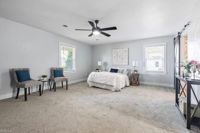 128 Wellons St, Suffolk, VA 23434 - carpeted bedroom featuring baseboards, a barn door, and ceiling fan