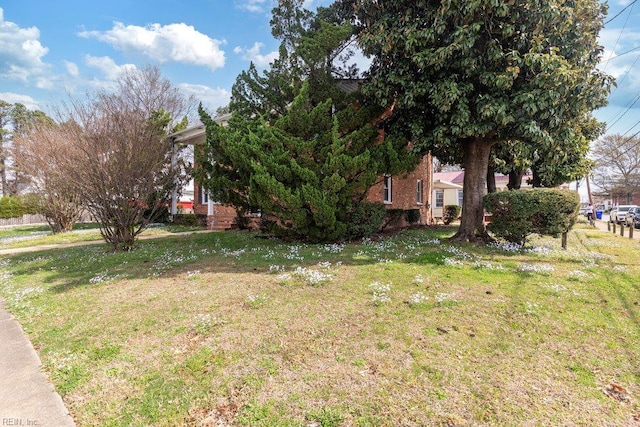 128 Wellons St, Suffolk, VA 23434 - view of property exterior with a lawn and brick siding