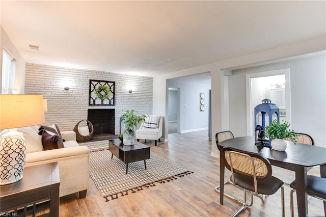 5553 Rock Creek Ln, Virginia Beach, VA 23462 - living room with a brick fireplace, light wood-type flooring, and baseboards