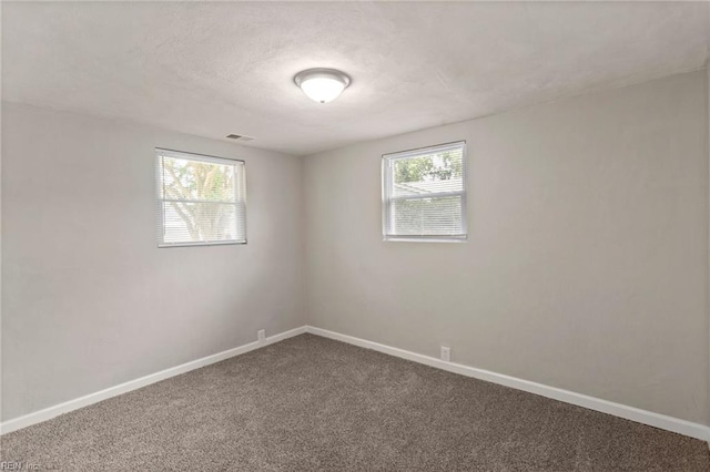 5553 Rock Creek Ln, Virginia Beach, VA 23462 - empty room featuring dark carpet, baseboards, and a textured ceiling