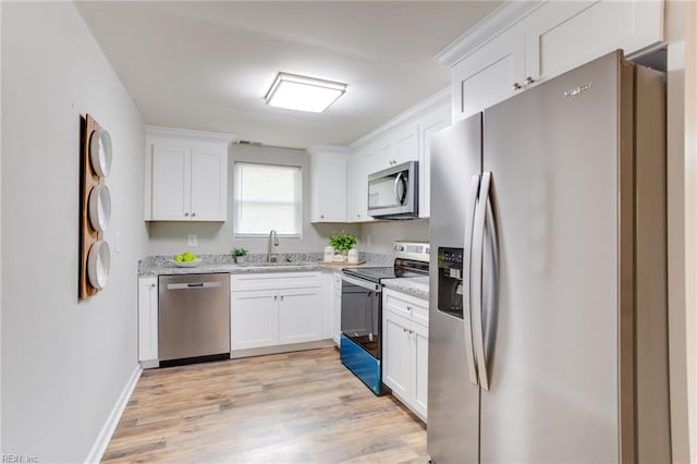 5553 Rock Creek Ln, Virginia Beach, VA 23462 - kitchen with stainless steel appliances, a sink, white cabinets, light wood finished floors, and light stone counters