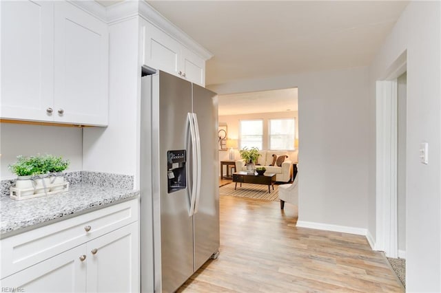 5553 Rock Creek Ln, Virginia Beach, VA 23462 - kitchen featuring stainless steel fridge with ice dispenser, light wood finished floors, white cabinets, light stone countertops, and baseboards