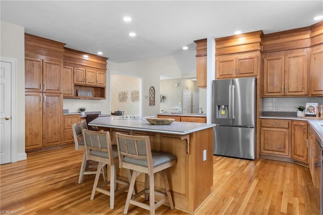 118 Goose Hill Way, Smithfield, VA 23430 - kitchen featuring stainless steel fridge with ice dispenser, open shelves, light wood finished floors, a kitchen island, and a kitchen breakfast bar