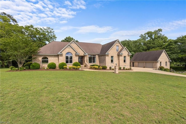 118 Goose Hill Way, Smithfield, VA 23430 - view of front of house with an outdoor structure, a front yard, brick siding, a detached garage, and concrete driveway