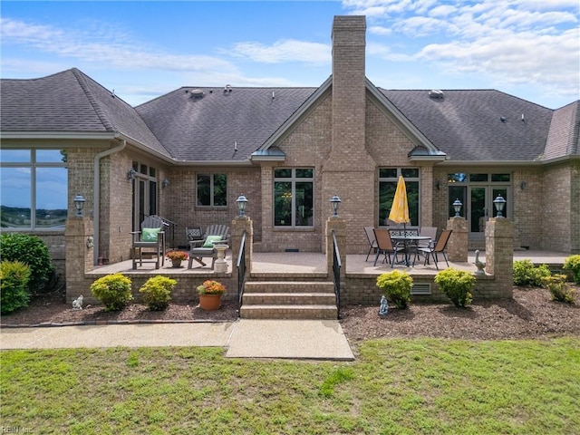 118 Goose Hill Way, Smithfield, VA 23430 - rear view of house with brick siding, a chimney, roof with shingles, and a yard