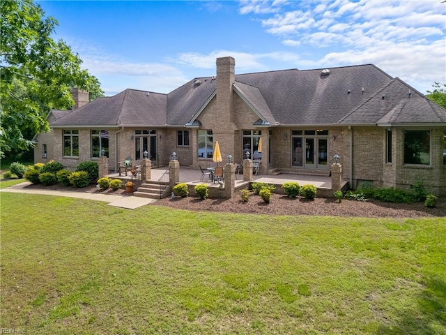 118 Goose Hill Way, Smithfield, VA 23430 - back of house with a patio area, a chimney, brick siding, a lawn, and french doors