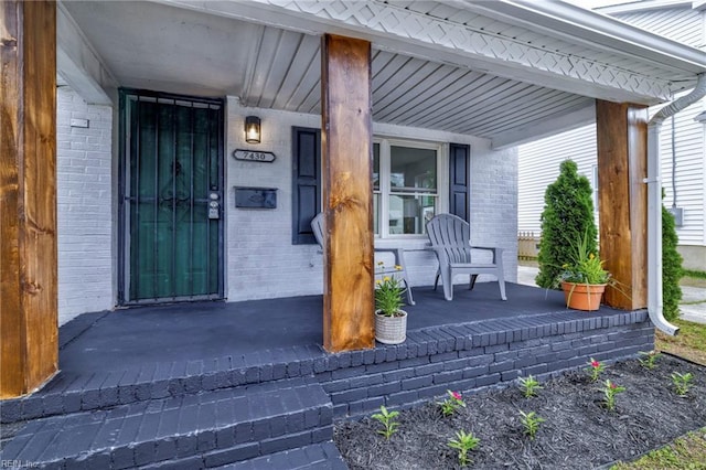 7430 Hughart St, Norfolk, VA 23505 - view of exterior entry featuring a porch and brick siding