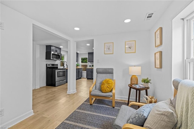 7430 Hughart St, Norfolk, VA 23505 - living room featuring light wood-type flooring, recessed lighting, and baseboards