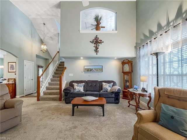 2884 Einstein Dr, Virginia Beach, VA 23456 - living room with a high ceiling, stairs, carpet, arched walkways, and a ceiling fan