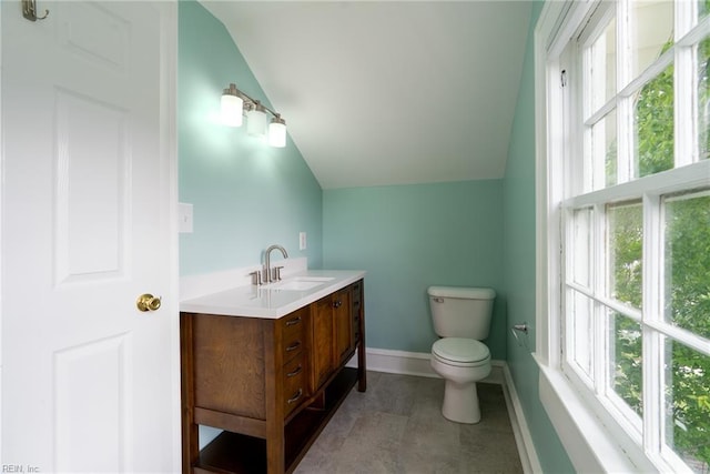 319 N First St, Hampton, VA 23664 - bathroom with lofted ceiling, vanity, healthy amount of natural light, toilet, and baseboards