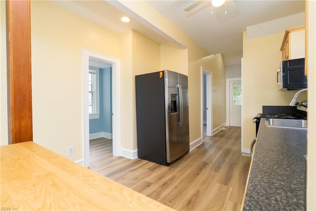 319 N First St, Hampton, VA 23664 - kitchen with stainless steel refrigerator with ice dispenser, range, light wood finished floors, a ceiling fan, and baseboards