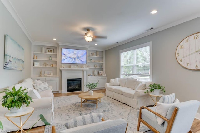 7412 Glenroie Ave, Norfolk, VA 23505 - living room with light wood-style flooring, crown molding, ceiling fan, a glass covered fireplace, and recessed lighting