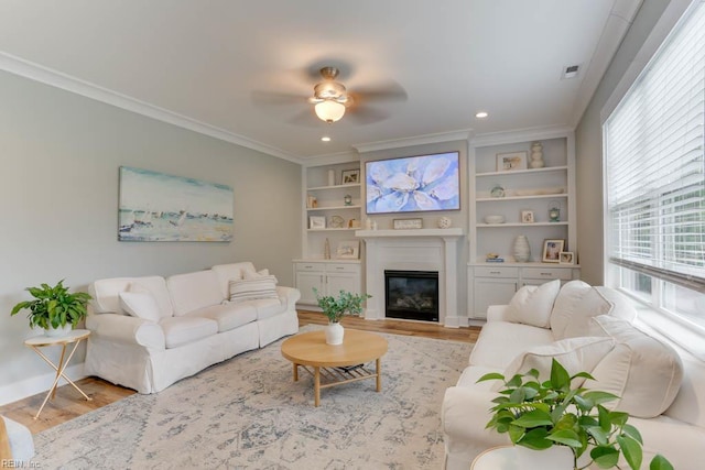 7412 Glenroie Ave, Norfolk, VA 23505 - living area with wood finished floors, ceiling fan, a glass covered fireplace, crown molding, and built in shelves