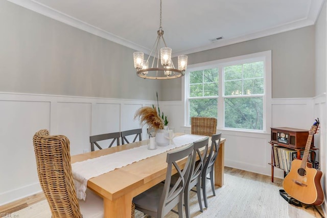 7412 Glenroie Ave, Norfolk, VA 23505 - dining room featuring a decorative wall, a chandelier, light wood-style floors, crown molding, and a wainscoted wall