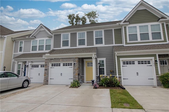 1621 Redwing Arch, Chesapeake, VA 23323 - townhome / multi-family property with driveway, an attached garage, stone siding, and a shingled roof