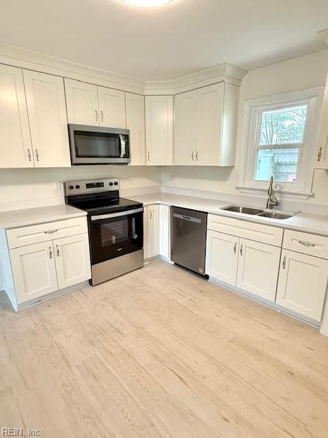 291 Fair Meadows Rd, Virginia Beach, VA 23462 - kitchen featuring appliances with stainless steel finishes, a sink, white cabinets, light countertops, and light wood-type flooring