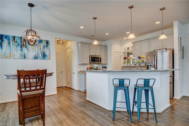3729 Longhill Arch, Chesapeake, VA 23323 - kitchen with appliances with stainless steel finishes, gray cabinetry, wood finished floors, light stone countertops, and recessed lighting