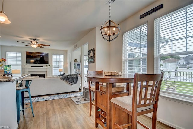 3729 Longhill Arch, Chesapeake, VA 23323 - dining room with plenty of natural light, a ceiling fan, a chandelier, and light wood-style flooring