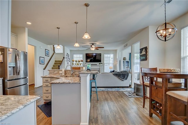 3729 Longhill Arch, Chesapeake, VA 23323 - kitchen featuring stainless steel fridge with ice dispenser, a sink, ceiling fan, a kitchen breakfast bar, and a chandelier