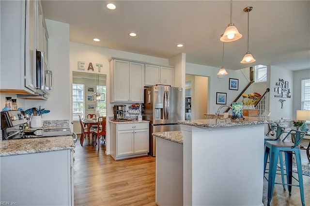 3729 Longhill Arch, Chesapeake, VA 23323 - kitchen with light wood finished floors, plenty of natural light, a kitchen bar, pendant lighting, and recessed lighting