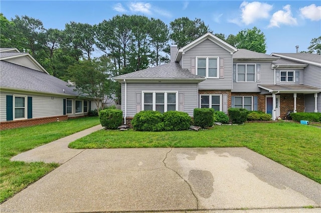 104 Pheasant Watch, Yorktown, VA 23692 - townhome / multi-family property with a front lawn, a chimney, and brick siding