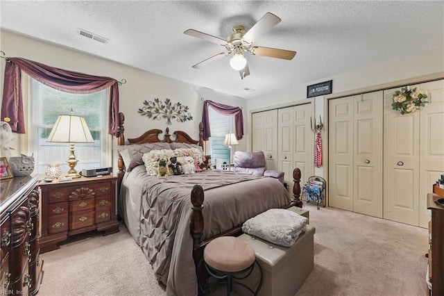 104 Pheasant Watch, Yorktown, VA 23692 - bedroom featuring light carpet, two closets, a textured ceiling, and a ceiling fan