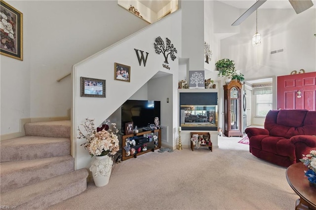 104 Pheasant Watch, Yorktown, VA 23692 - living area with carpet, a high ceiling, stairway, and baseboards