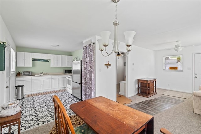 221 Herbert Ave, Hampton, VA 23664 - kitchen with stainless steel appliances, white cabinets, a chandelier, light countertops, and hanging light fixtures