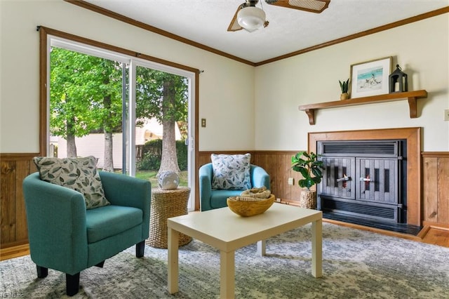 214 Silver Isles Blvd, Hampton, VA 23664 - living room with wainscoting, wood walls, wood finished floors, crown molding, and ceiling fan
